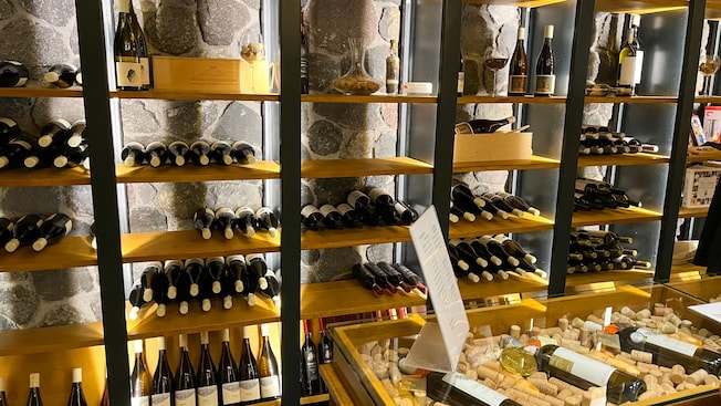 A shelf with bottles of wine in a wine tasting room in Santorini, Greece A shelf with bottles of wine in a wine tasting room in Santorini, Greece