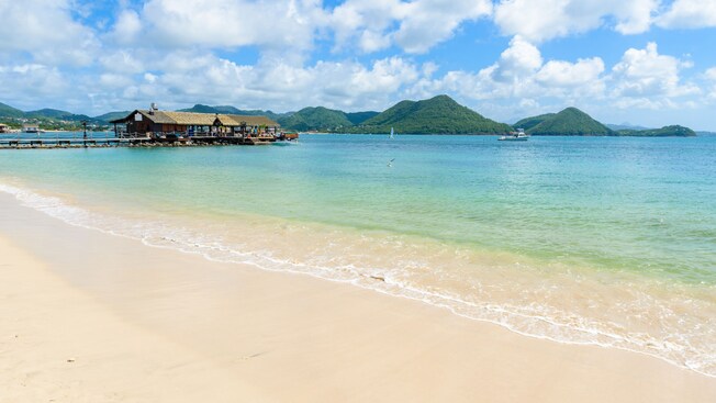 A sandy beach and a pavilion at the end of a jetty at Pigeon Island National Park in Saint Lucia