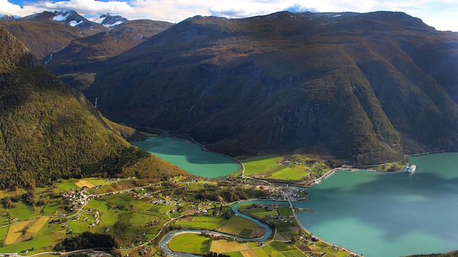 A mountainous landscape in Skjolden, Norway with farmland, houses and winding waterways A mountainous landscape in Skjolden, Norway with farmland, houses and winding waterways