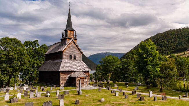 A cemetery surrounding the wooden Kaupanger Stave church in Norway