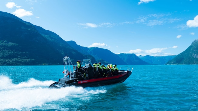 A tour group riding in a rigid inflatable boat across an inlet on the Sognefjord A tour group riding in a rigid inflatable boat across an inlet on the Sognefjord