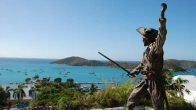 A statue of a pirate with his sword drawn, guarding a bay A statue of a pirate with his sword drawn, guarding a bay