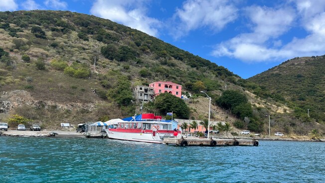 A catamaran on the water next to Jost Van Dyke in the British Virgin Islands