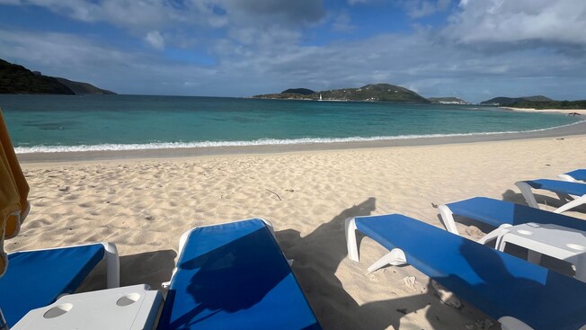 Beach chairs on the shore of a sandy beach