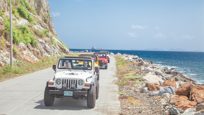 Four off road vehicles driving along the shore of Tortola Four off road vehicles driving along the shore of Tortola