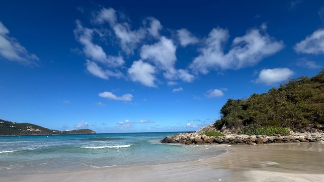 A sandy beach with gentle waves A sandy beach with gentle waves