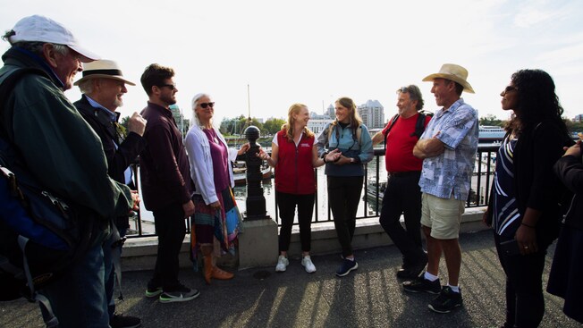 A group of people listen to a tour guide