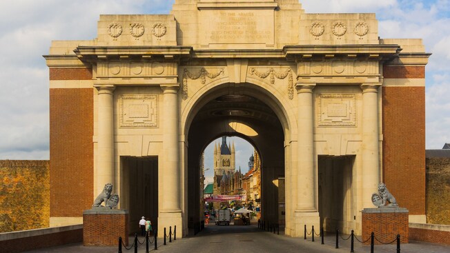 Façade of the Menin Gate with a stone archway and 3 lion statues in Ypres, Belgium