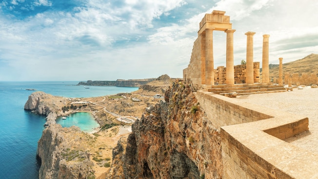 The Acropolis of Lindos sitting atop a cliff overlooking the sea in Rhodes, Greece The Acropolis of Lindos sitting atop a cliff overlooking the sea in Rhodes, Greece