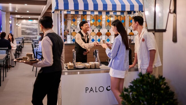 Two Guests picking up food from Palo Café aboard the Disney Adventure cruise ship
