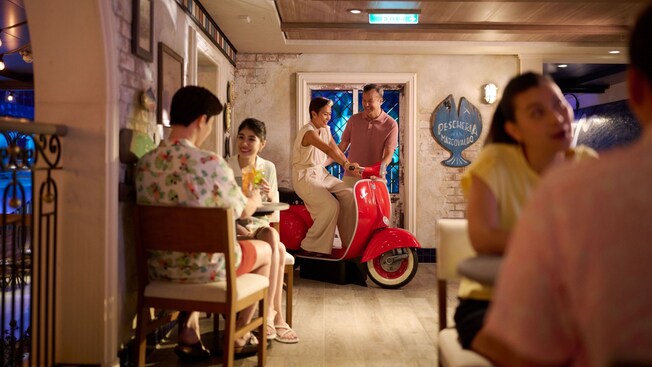 Guests dining in Tavern Portorosso aboard the Disney Adventure cruise ship" style