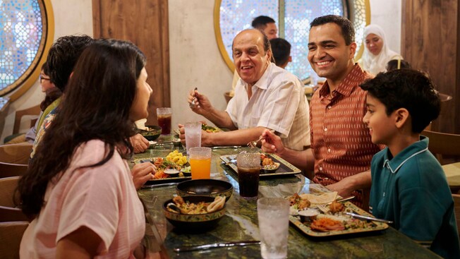 A family dining at Mowgli's Eatery on the Disney Adventure cruise ship" style