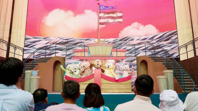 The cast from Duffy and The Friend Ship performing on stage in front of an audience aboard the Disney Adventure cruise ship
