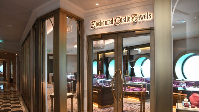 The exterior of Enchanted Castle Jewels reveals double doors and windows that look into an upscale jewelry shop