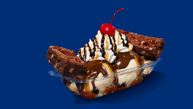 Vanilla ice cream topped with whipped cream, hot fudge and caramel sauce served with brownies