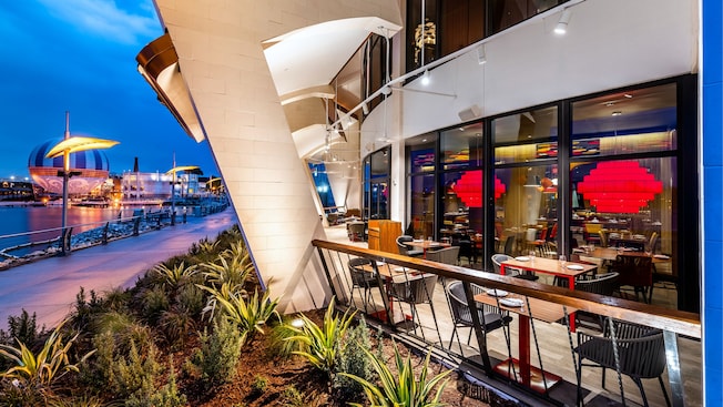 A terrace at Jaleo by José Andrés with tables for 2 people near the lake at Disney Springs