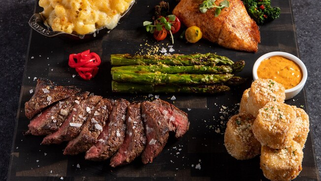 An assortment of food including steak, hamburgers, seafood and sides at S T K Orlando
