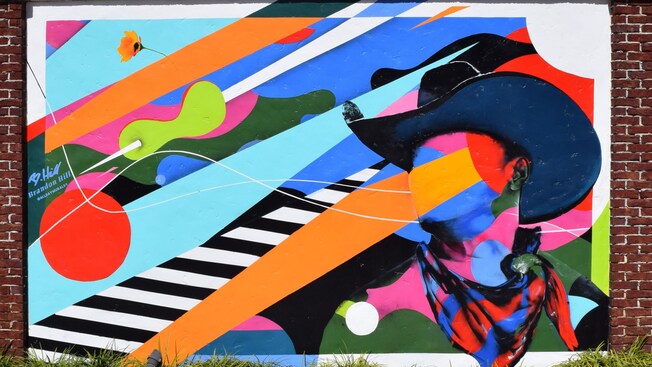 Artist Brandon Hill and his mural honoring the wild west's Black cowboys unveiled at Disney Springs Art Walk