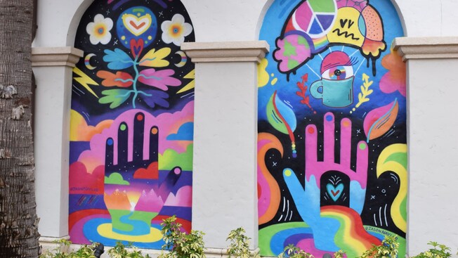 Two murals featuring abstract hands and geometric designs