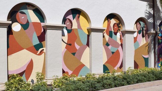 Artist Liz Flores and her mural honoring Women's History Month at Disney Springs Art Walk