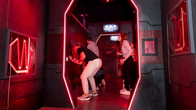 Guests working together in an escape room made to look like the interior of a starship