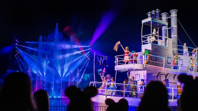 Mickey Mouse steers a steamboat carrying Tiana, Belle and other Disney Characters