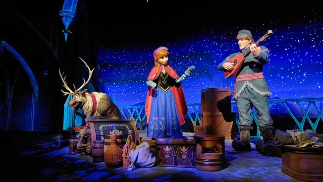 Sven, Anna and Kristoff surrounded by luggage and props on the Frozen Ever After attraction