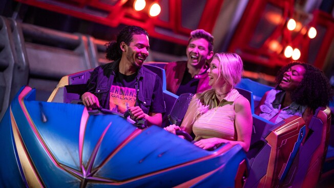4 Guests laughing after riding Guardians of the Galaxy: Cosmic Rewind