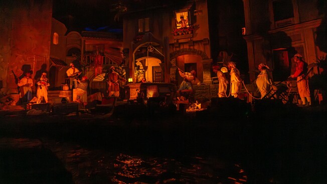 A scene from the Pirates of The Caribbean attraction featuring pirates engaged in different activities