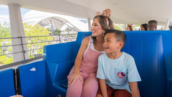 A mother and son riding the Tomorrowland Transit Authority PeopleMover at Magic Kingdom park 