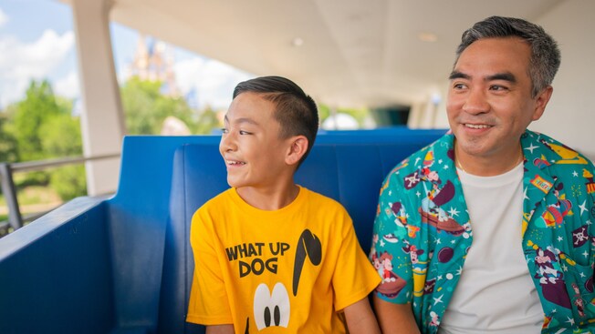 A father and son riding the Tomorrowland Transit Authority PeopleMover at Magic Kingdom park