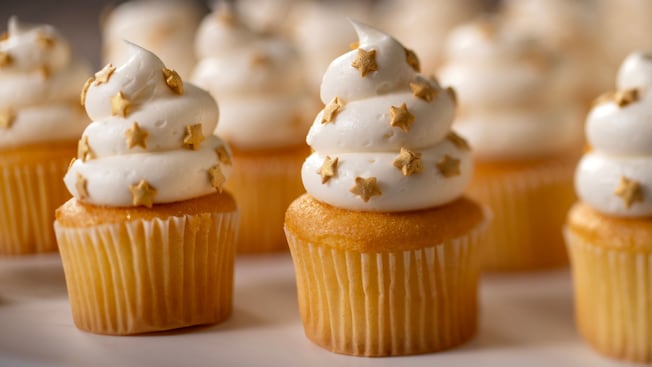 A group of vanilla cupcakes with frosting and star sprinkles at Nineteen Hundred Park Fare