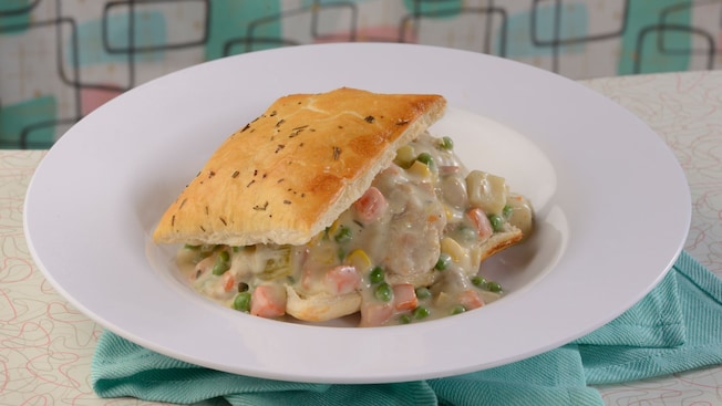 Chicken pot pie filled with chicken, potatoes, and vegetables topped with a pastry crust