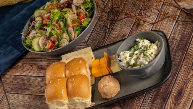 Plant based bread, cinnamon butter, olive oil mashed potatoes, assorted cheeses and a bowl of mixed greens