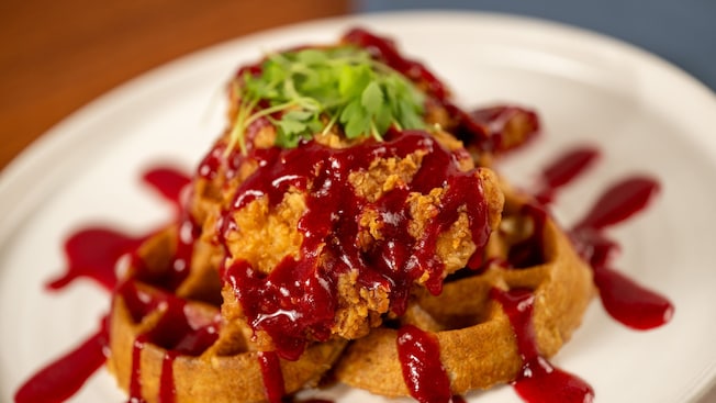 Chicken and Waffles from Ale & Compass, garnished with sauce and parsley