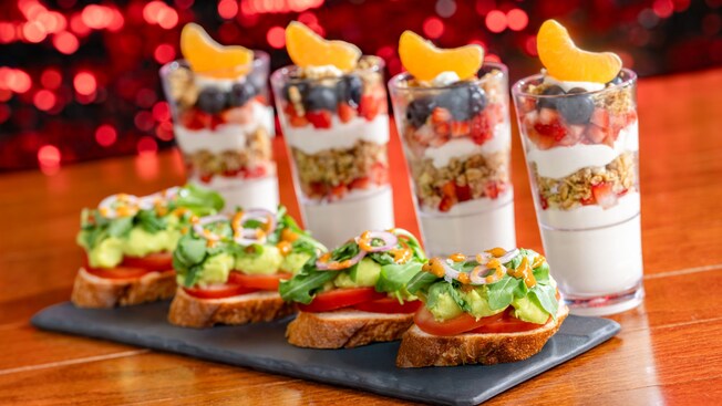 Avocado toast pieces on a platter next to 4 yogurt parfaits, at Chef Mickey’s