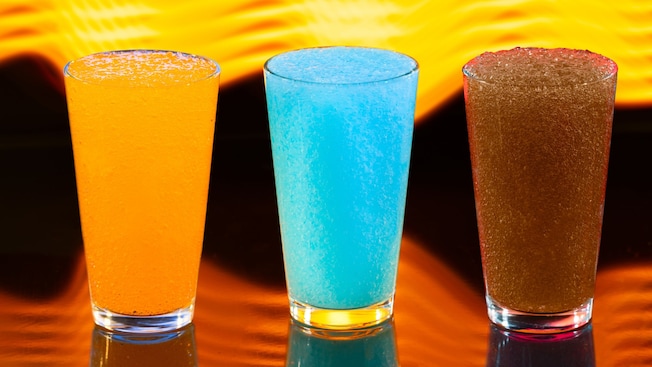 Three glasses with orange, blue and brown colored Frozen Slushies from Astrofizz