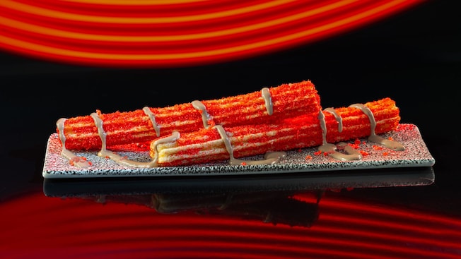 A plate with 2 Cherry Cola Churros from Astrofizz