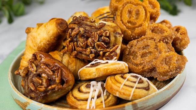 A breakfast pastry platter from The Crystal Palace with Churro Mickey Waffles, cinnamon rolls, pecan buns and croissants
