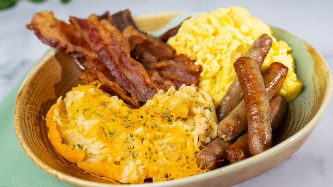 A breakfast platter from The Crystal Palace with eggs, bacon, sausages and cheesy potatoes
