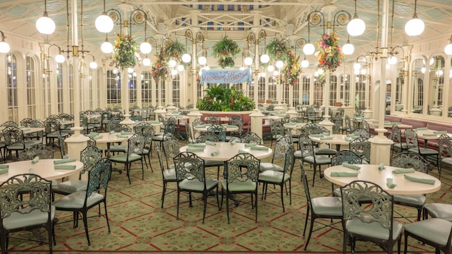 The Victorian greenhouse inspired dining room of The Crystal Palace at Magic Kingdom park