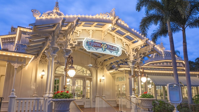 The entrance and exterior of The Crystal Palace at Magic Kingdom park, inspired by Victorian greenhouses