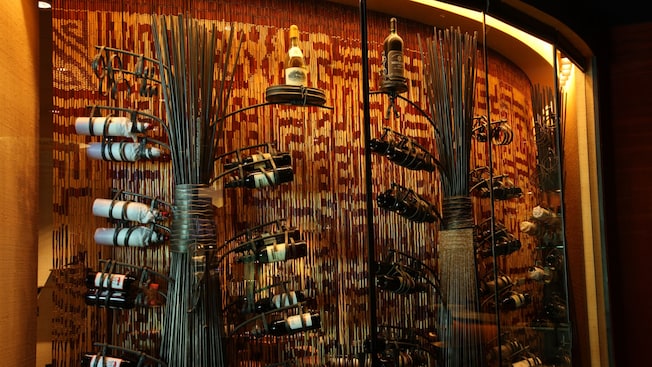 Two wine racks holding several bottles of wine