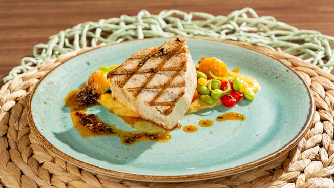 Grilled fish fillet with edamame, roasted tomatoes and citrus sauce