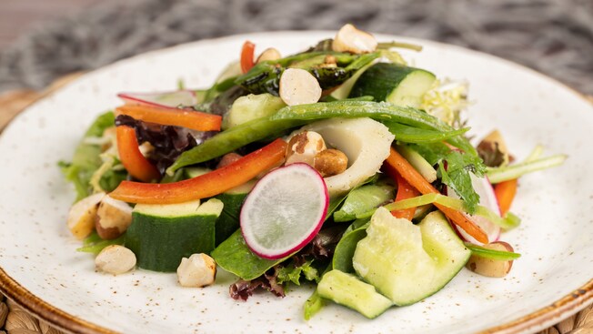 Green salad featuring carrots, eggs, cucumbers and peppers