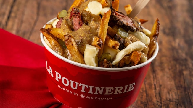 Montreal Viande Fumée poutine with french fries, cheese curds, smoked meat, pickles, and mustard gravy