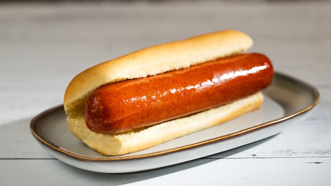 A hot dog in a bun on a plate