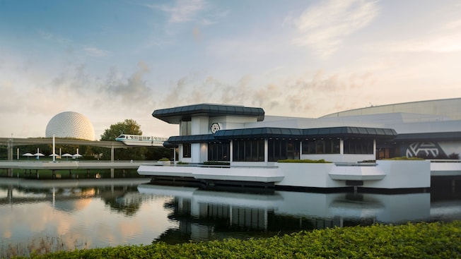 Exterior shot of The Odyssey next to a lagoon with Monorail Teal and Spaceship Earth in the background