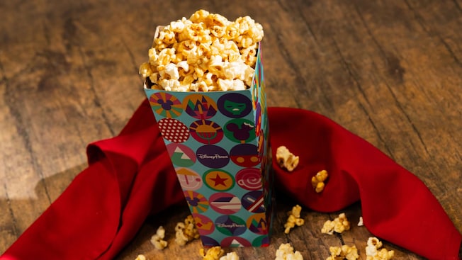 A bucket of maple flavored popcorn is garnished with an elegant cloth napkin