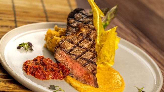 A steak served on a plate with garnish